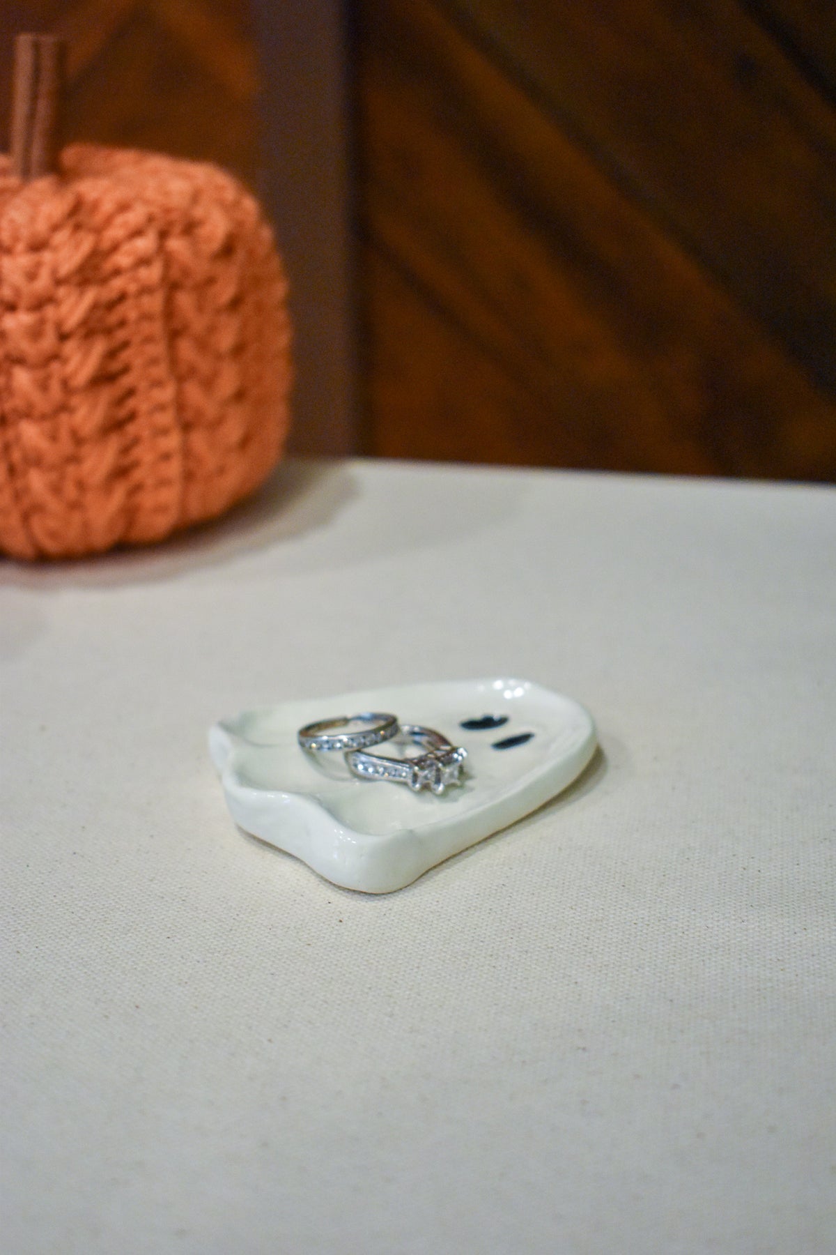 Hand-sculpted ceramic ghost ring dish in glossy white with two small black eyes