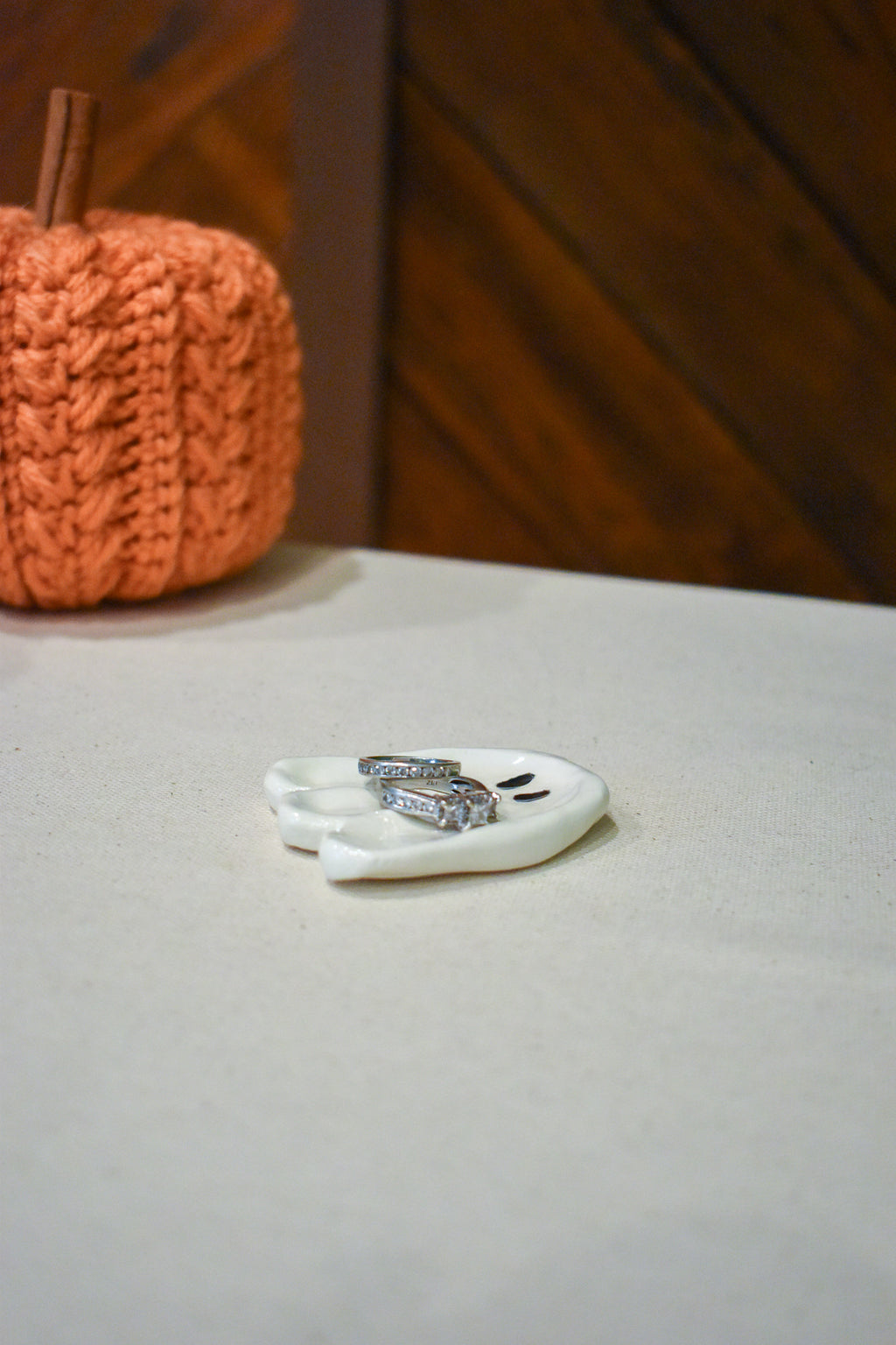 Hand-sculpted ceramic ghost ring dish in glossy white with two small black eyes