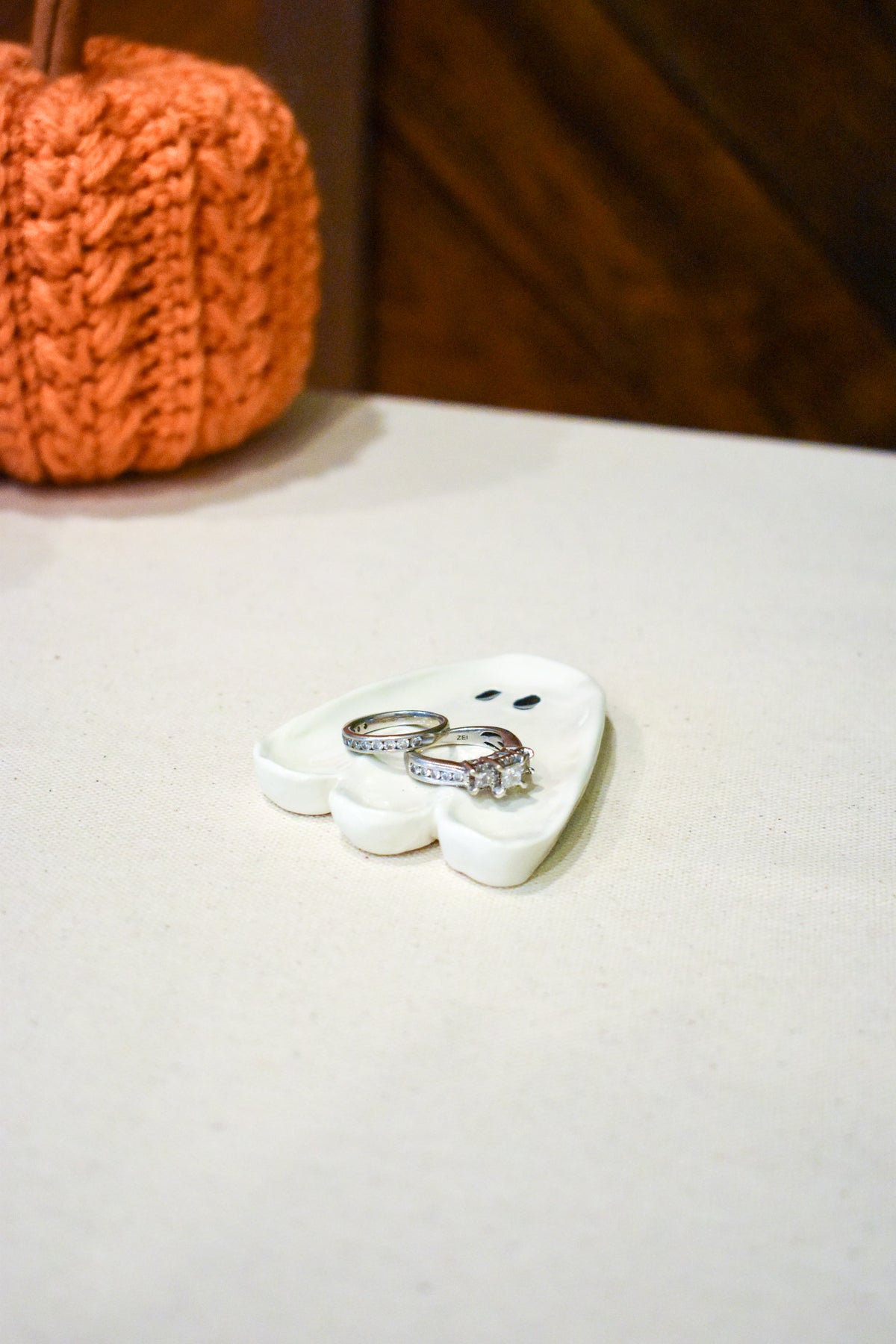 Hand-sculpted ceramic ghost ring dish in glossy white with two small black eyes
