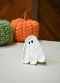 Hand-sculpted ceramic ghost ring dish in glossy white with two small black eyes