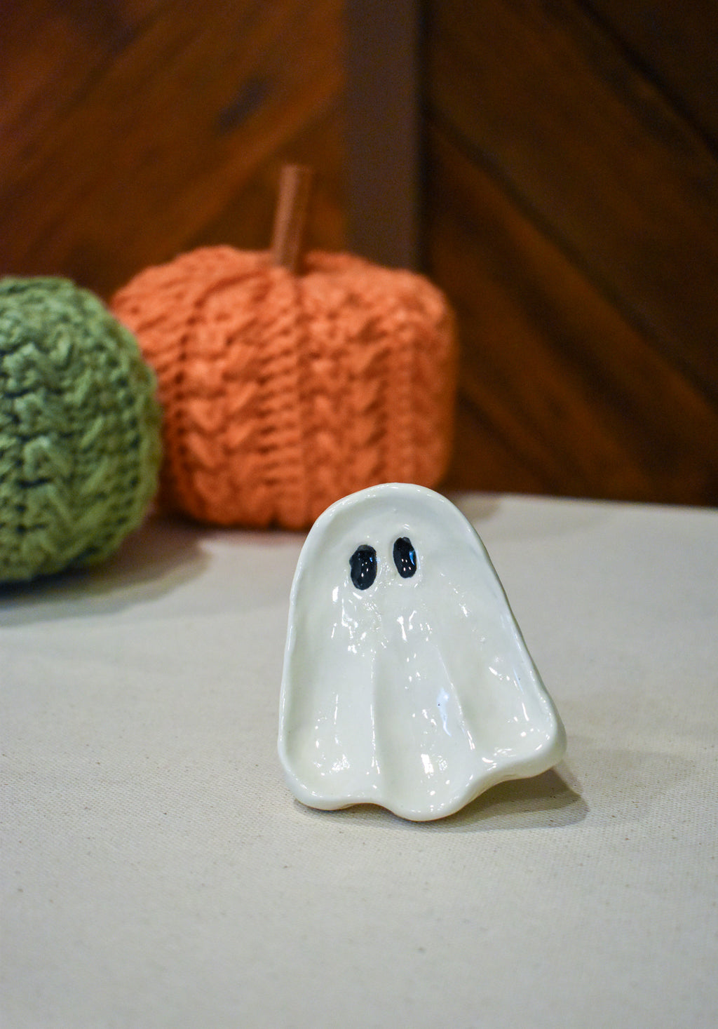 Hand-sculpted ceramic ghost ring dish in glossy white with two small black eyes