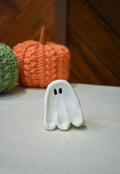 Hand-sculpted ceramic ghost ring dish in glossy white with two small black eyes