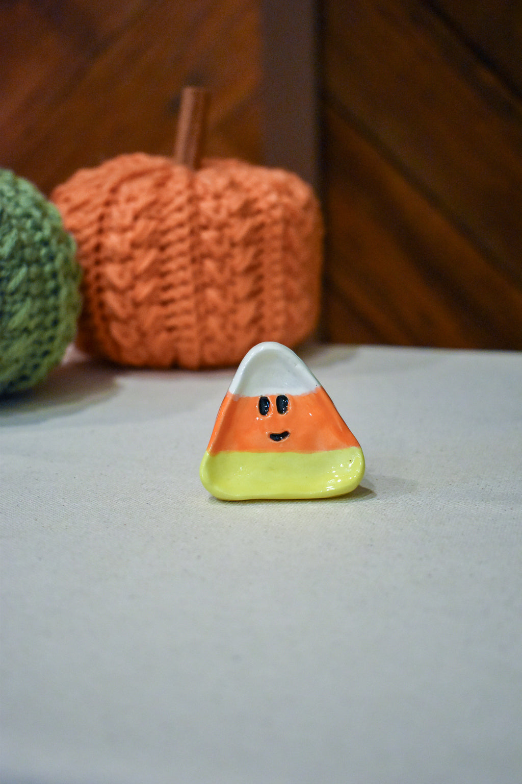 Hand-sculpted ceramic candy corn ring dish in white, orange, and yellow