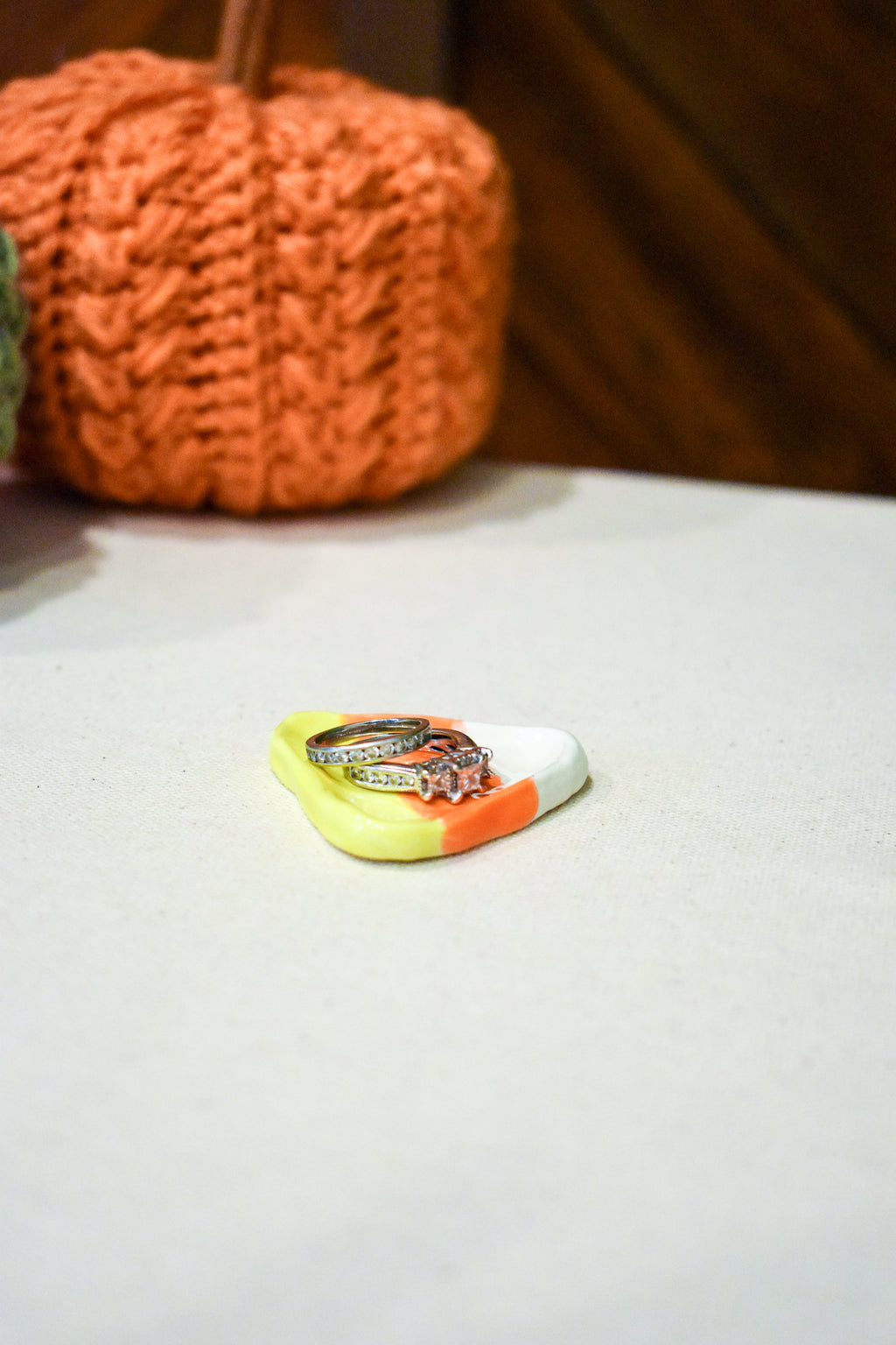 Hand-sculpted ceramic candy corn ring dish in white, orange, and yellow