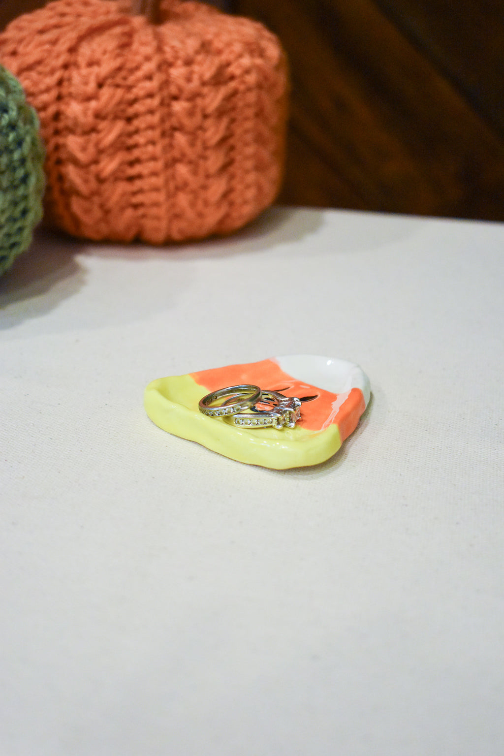 Hand-sculpted ceramic candy corn ring dish in white, orange, and yellow