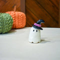 Hand-sculpted ceramic ghost in a pointed black witch hat