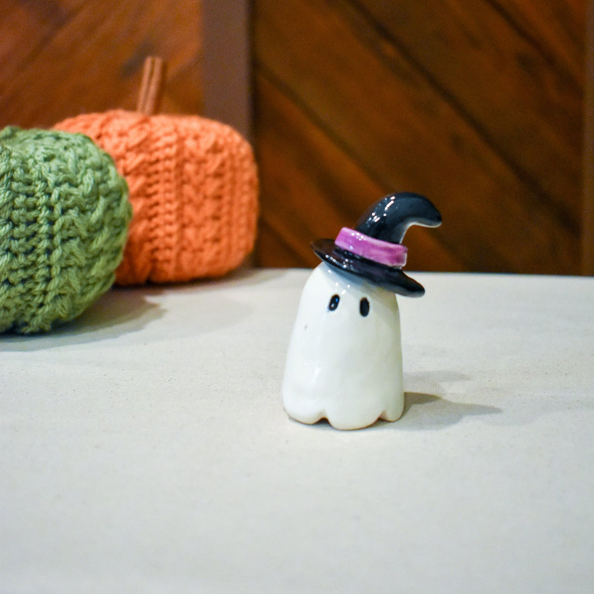 Hand-sculpted ceramic ghost in a pointed black witch hat