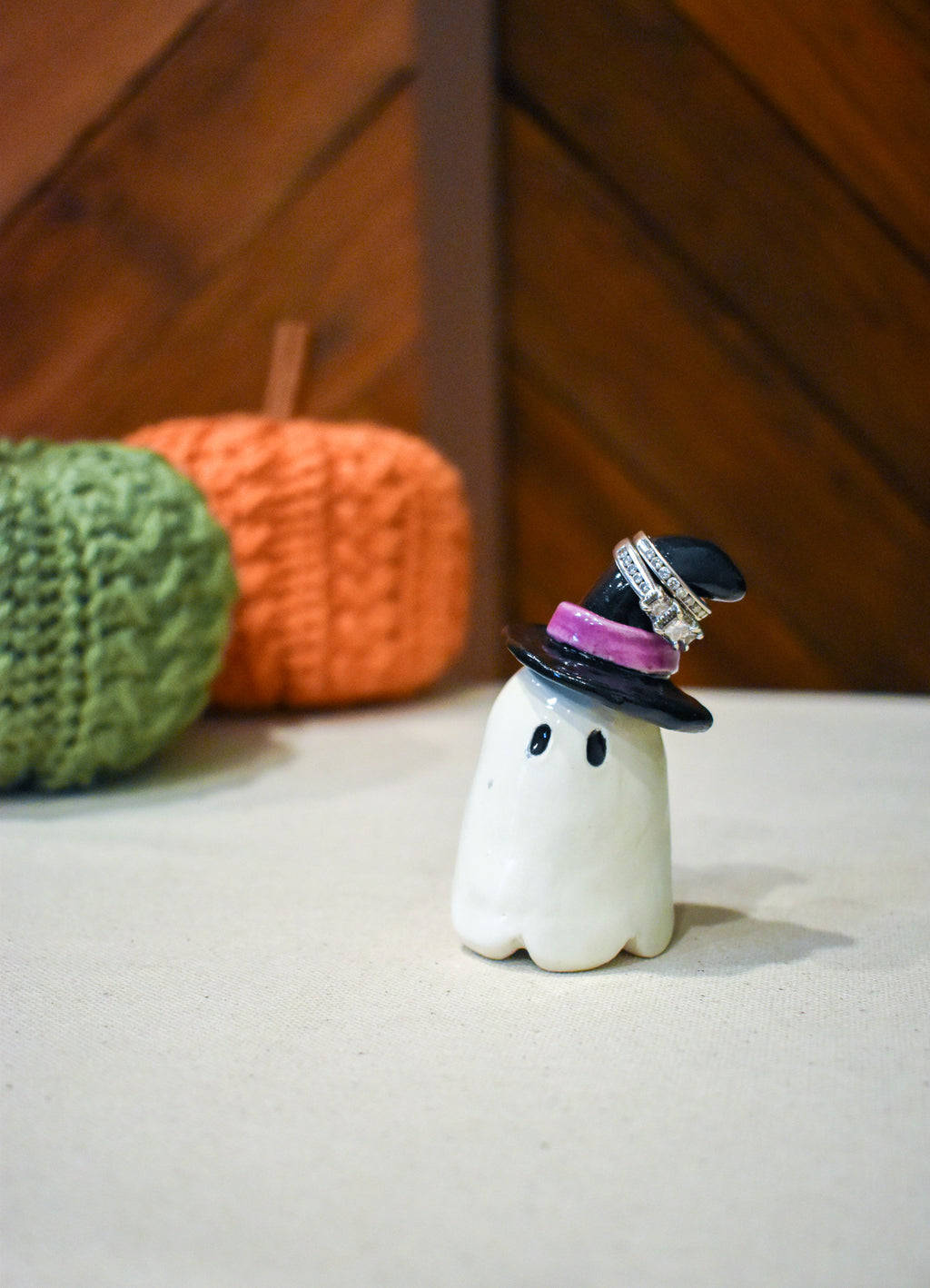 Hand-sculpted ceramic ghost in a pointed black witch hat