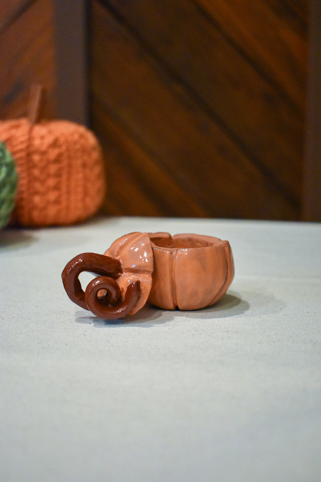 Hand-sculpted ceramic pumpkin jar with a lift-off lid, in glossy persimmon orange