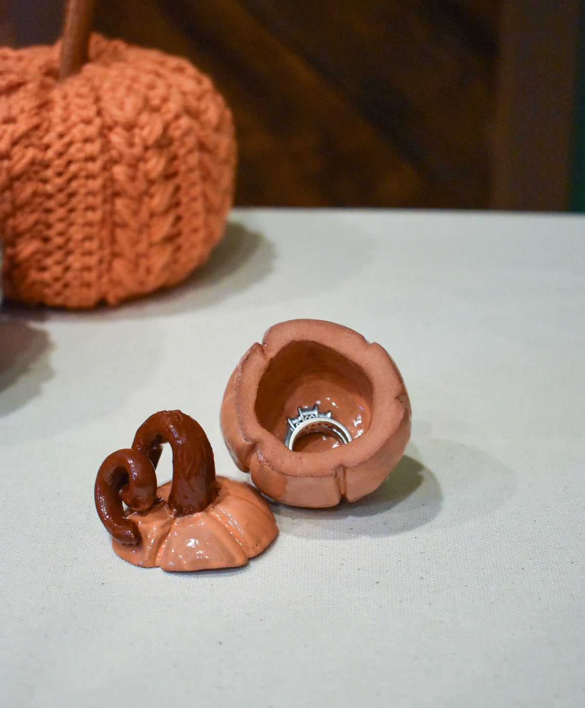 Hand-sculpted ceramic pumpkin jar with a lift-off lid, in glossy persimmon orange