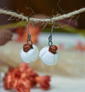 Tiny hand-sculpted ceramic white pumpkin earrings on titanium hooks