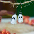 Tiny hand-sculpted ceramic ghost earrings on titanium hooks