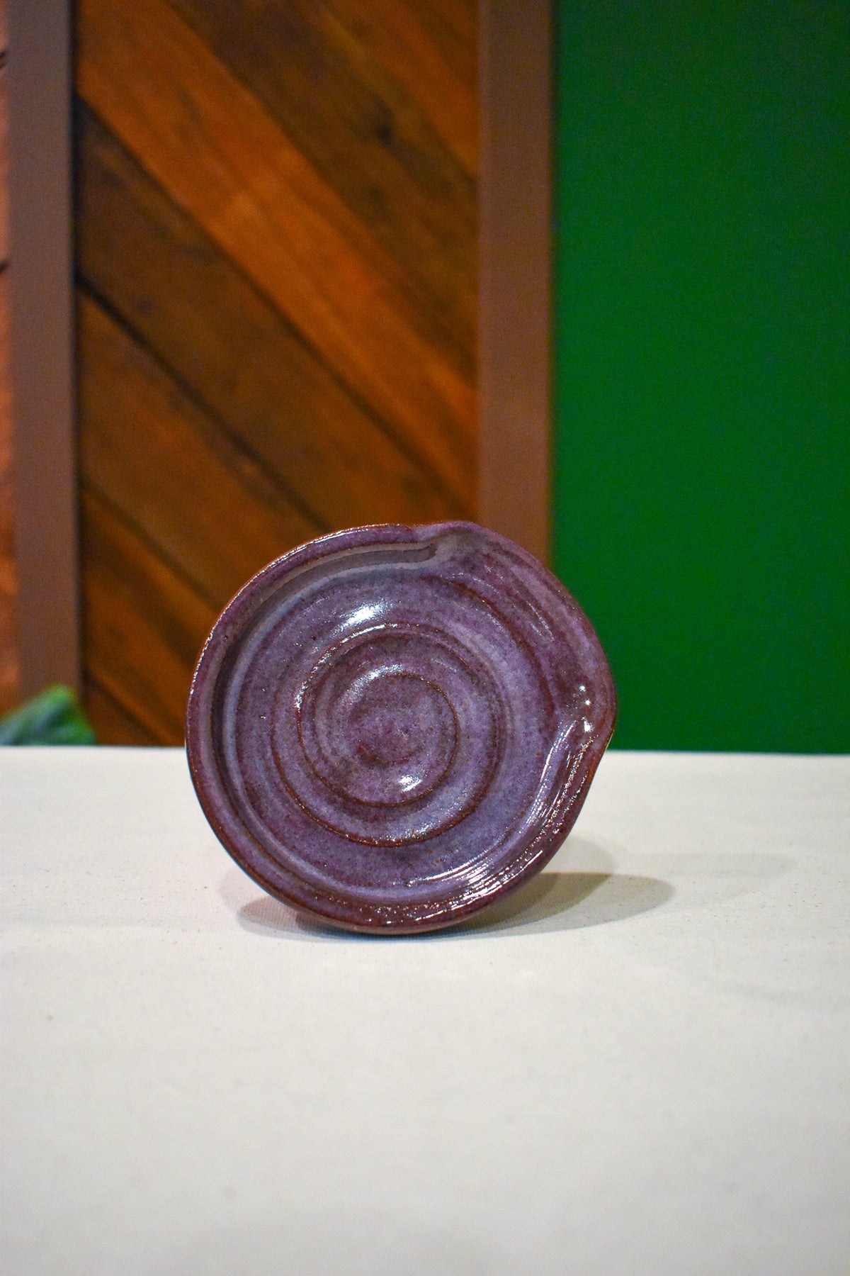 Hand-thrown spiral spoon rest in Deep Plum, soft mauve-plum
