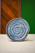 Hand-thrown spiral spoon rest in Storm Front, dusty blue with a dark iron rim