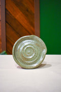 Hand-thrown spiral spoon rest in Matcha, pale celadon green with fine speckle