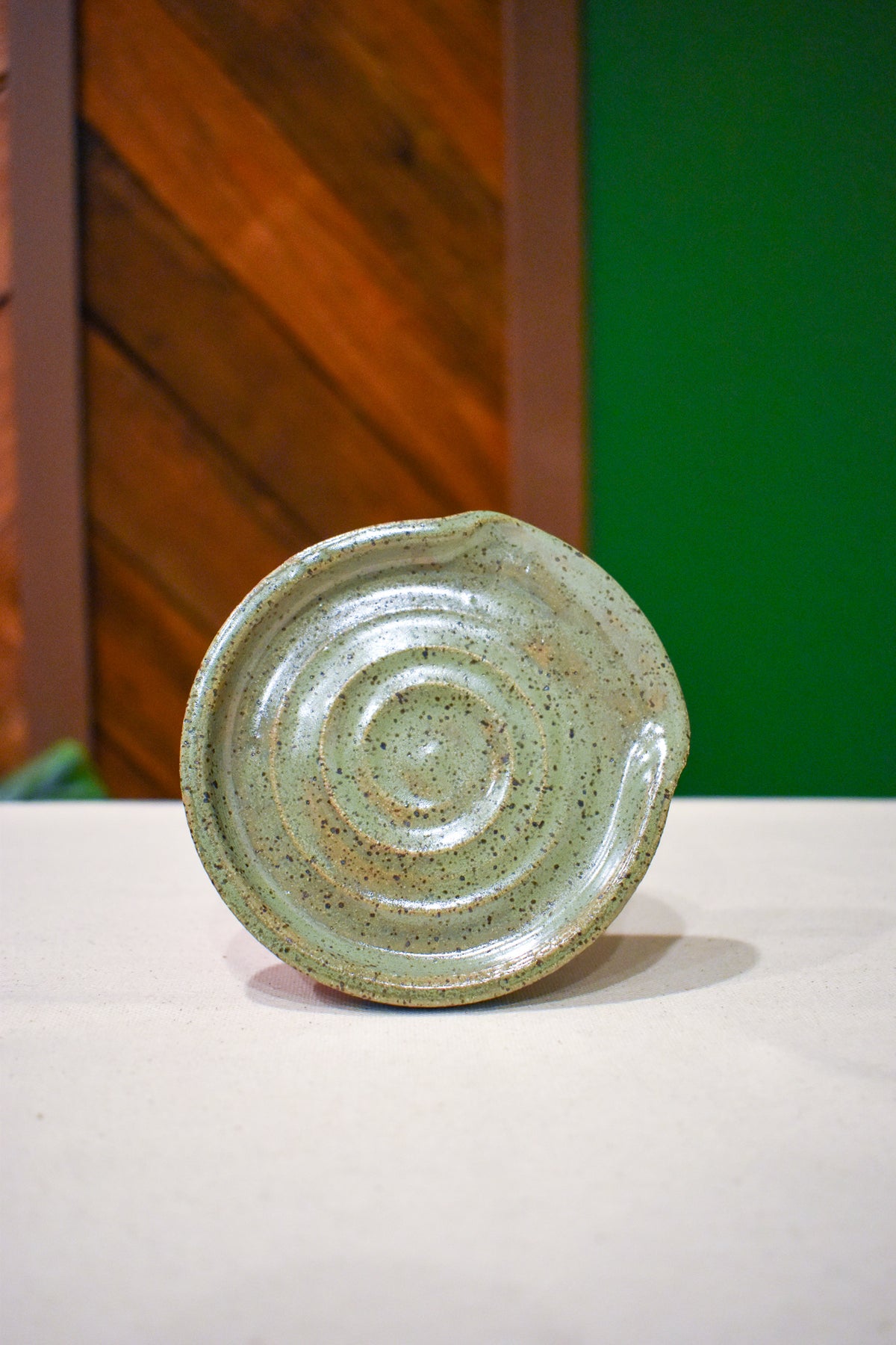 Hand-thrown spiral spoon rest in Matcha, pale celadon green with fine speckle