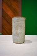 Hand-thrown ceramic travel mug in Linen, pale sage-gray and oatmeal with fine rust speckle