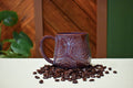 Hand-thrown mug with carved topographic ridges in Deep Plum, dusty rose to lavender at the rim with rust in the carved lines