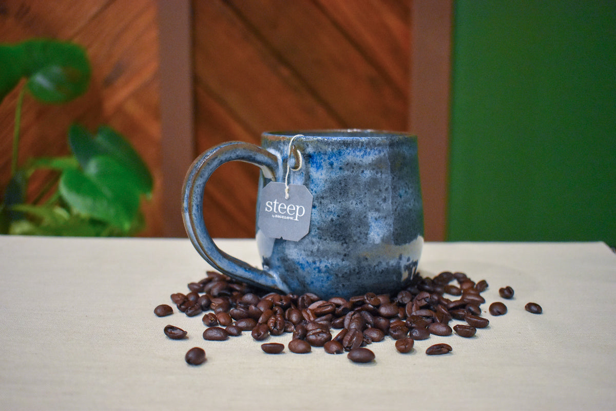 Hand-thrown mug in Deep Tide, deep storm-blue glaze mottled with cobalt and soft cream