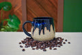 Hand-thrown mug in Midnight Drop, deep cobalt glaze dripping from the rim over a speckled clay body