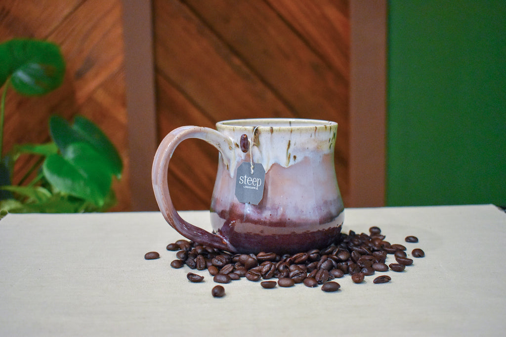 Hand-thrown mug in Orchard Mist, cream drips over dusty rose and deep wine red