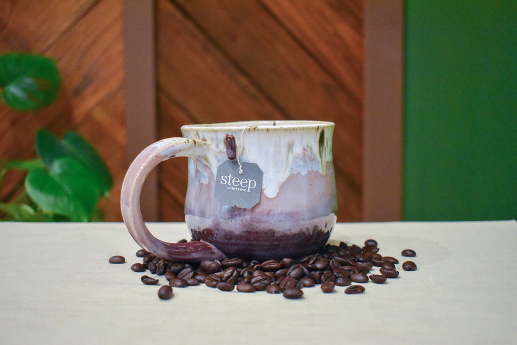 Hand-thrown mug in Orchard Mist, cream drips over dusty rose and deep wine red