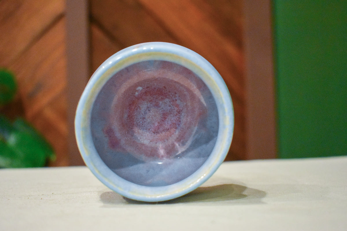 Small hand-thrown cup in Blush Bloom, petal pink rising from the base through lavender to frosted blue at the rim