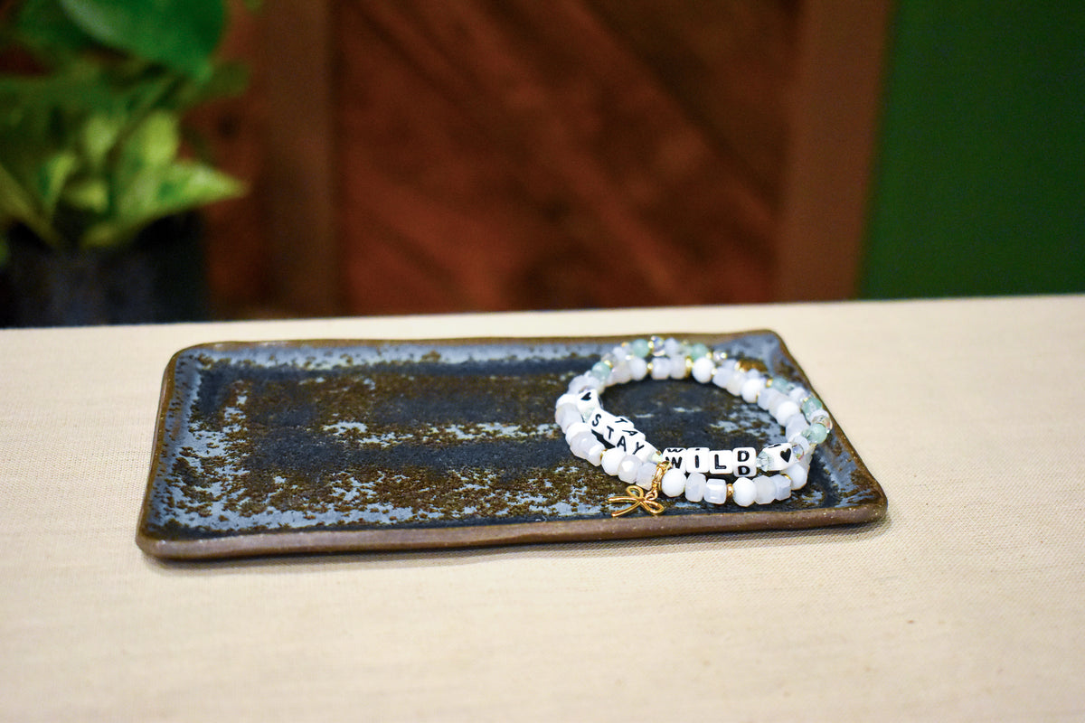 Hand-formed long rectangular catch-all dish in Tide & Earth, deep teal-blue glaze with warm iron speckling