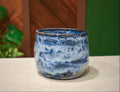 Hand-thrown open-form vase in Storm Front, mottled cobalt and navy with white and pale yellow and a dark iron rim