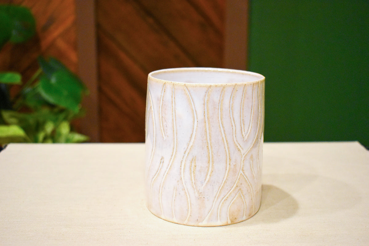Hand-thrown utensil crock in Whitewood, matte white glaze over carved wood-grain lines with tan in the grooves