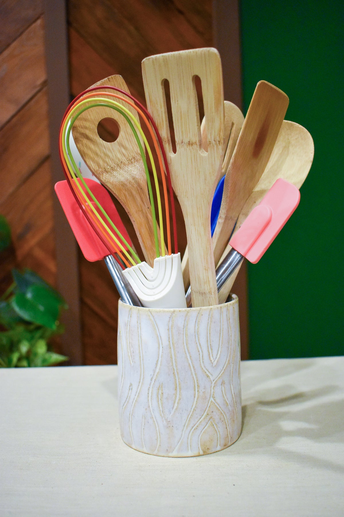 Hand-thrown utensil crock in Whitewood, matte white glaze over carved wood-grain lines with tan in the grooves