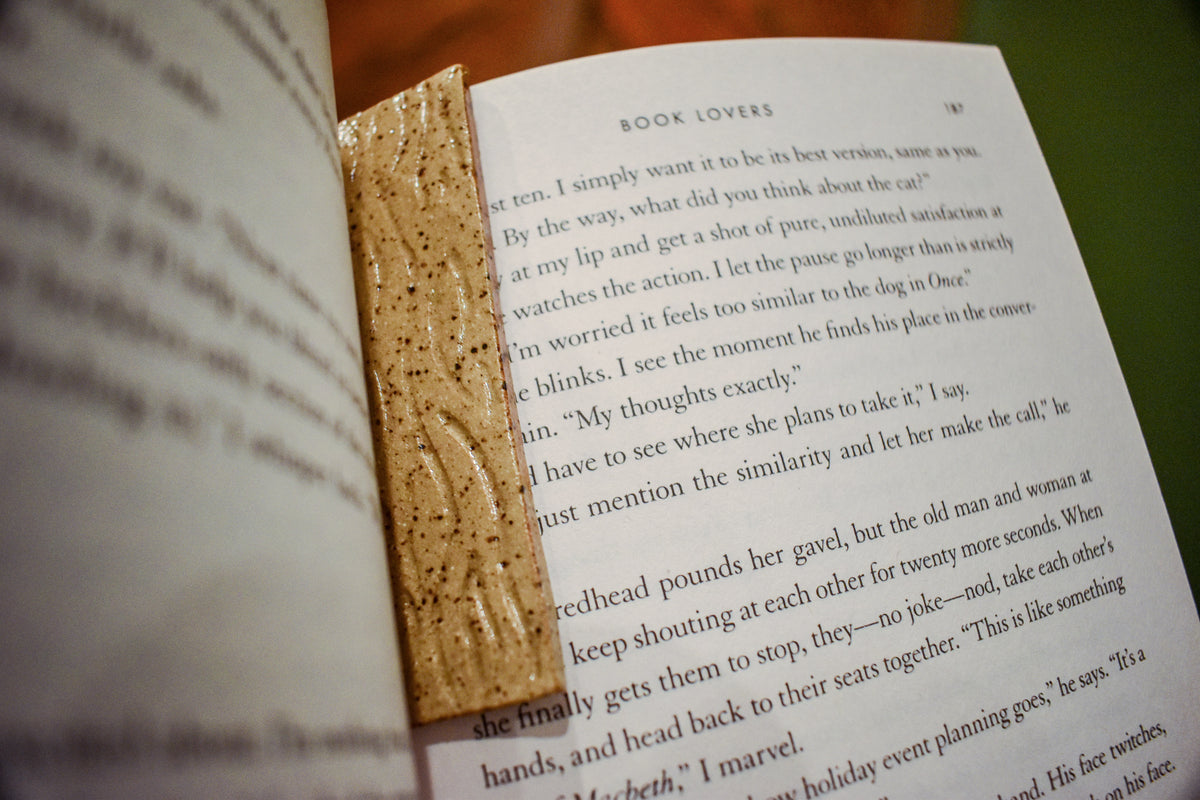 Hand-formed stoneware bookmark in Woodgrain, bare speckled clay with carved wood-grain lines glazed clear