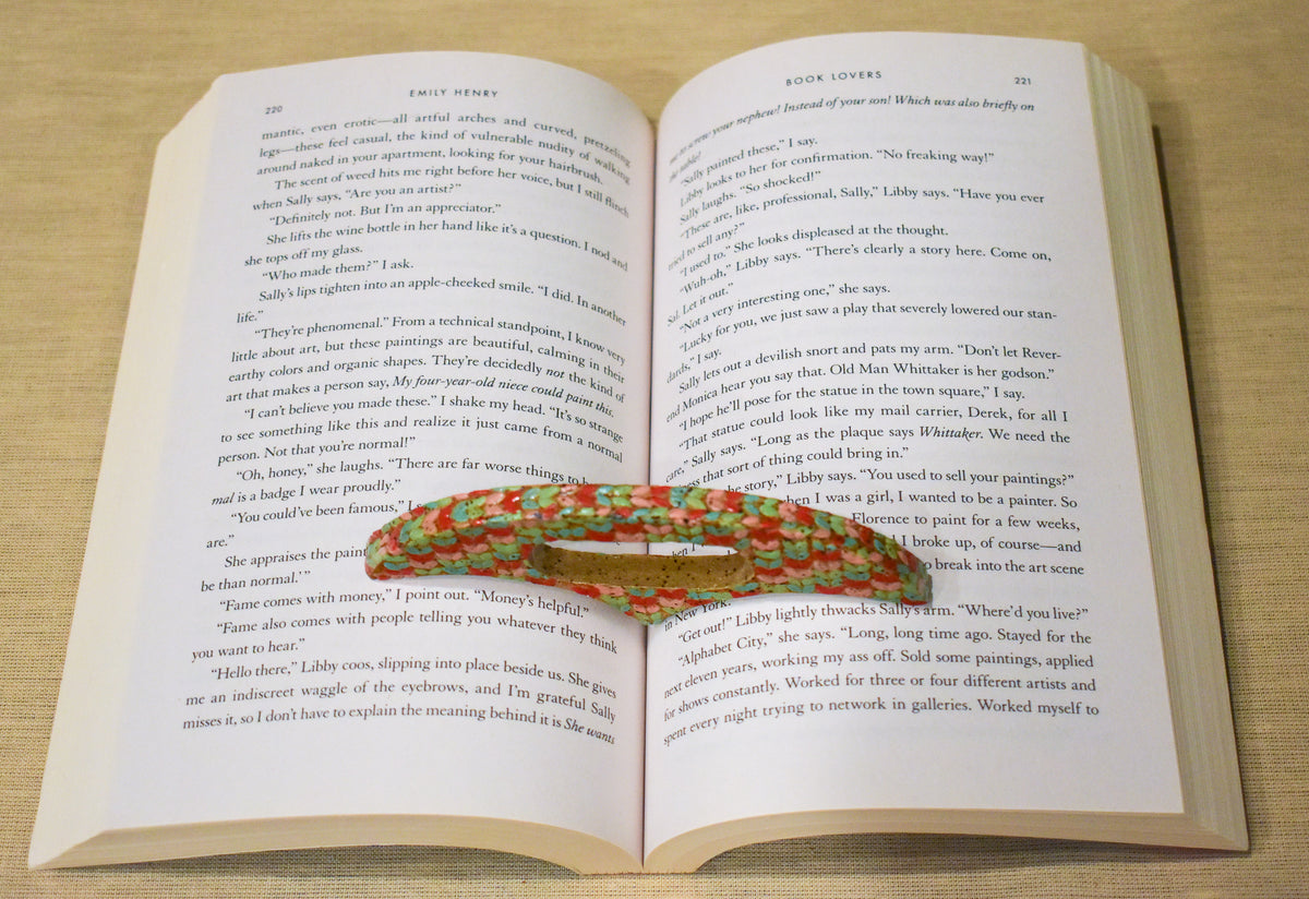 Hand-formed ceramic thumb book holder in Sherbet Knit, knit-stitch texture in mint, coral and soft pink