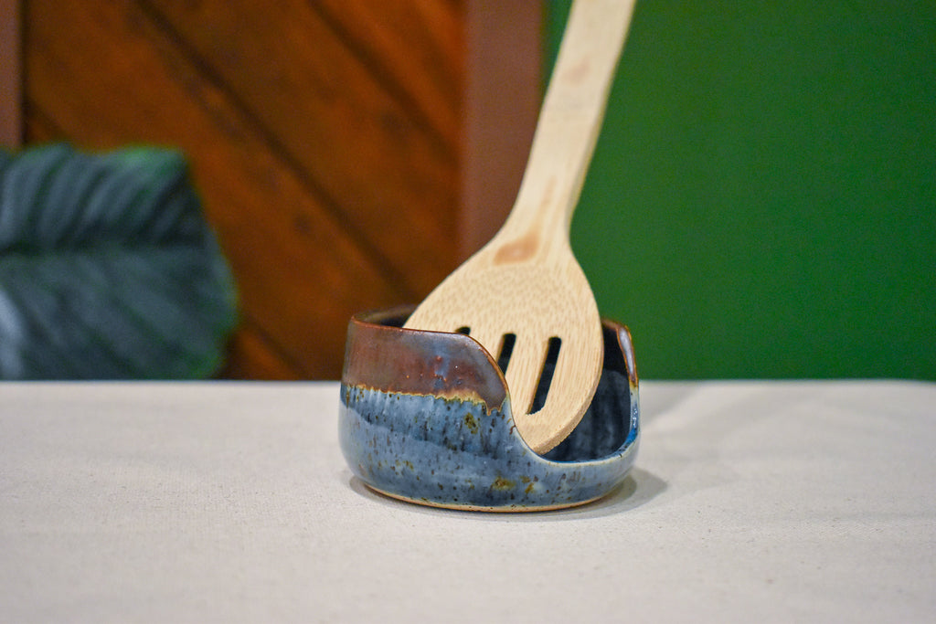 Small upright hand-thrown spoon rest in Iron Blue, slate blue with speckle and a rust rim, with a notch for the spoon handle