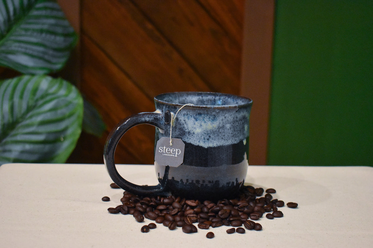 Hand-thrown mug in Night Surf, frosted white and grey froth over deep charcoal and slate