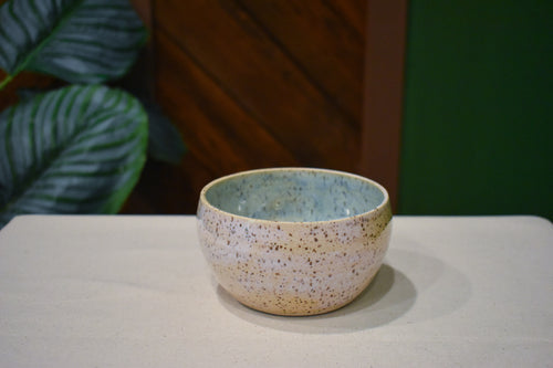 Hand-thrown bowl in Shallows, speckled oatmeal cream outside and pale blue-green pooling inside