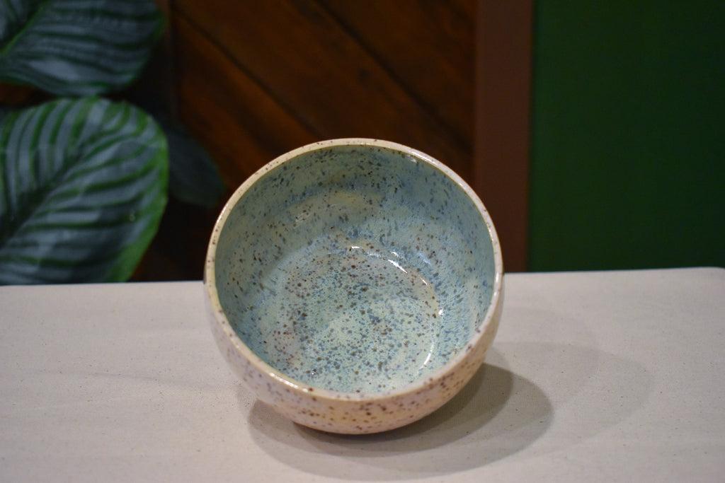 Hand-thrown bowl in Shallows, speckled oatmeal cream outside and pale blue-green pooling inside