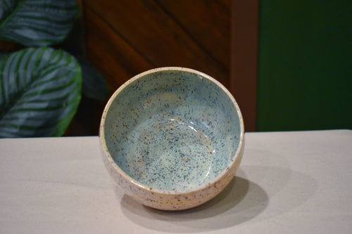 Hand-thrown bowl in Shallows, speckled oatmeal cream outside and pale blue-green pooling inside