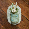 Large hand-formed wall vase in Sea Glass, an aqua sea-green bark-textured pocket on a speckled cream back plate
