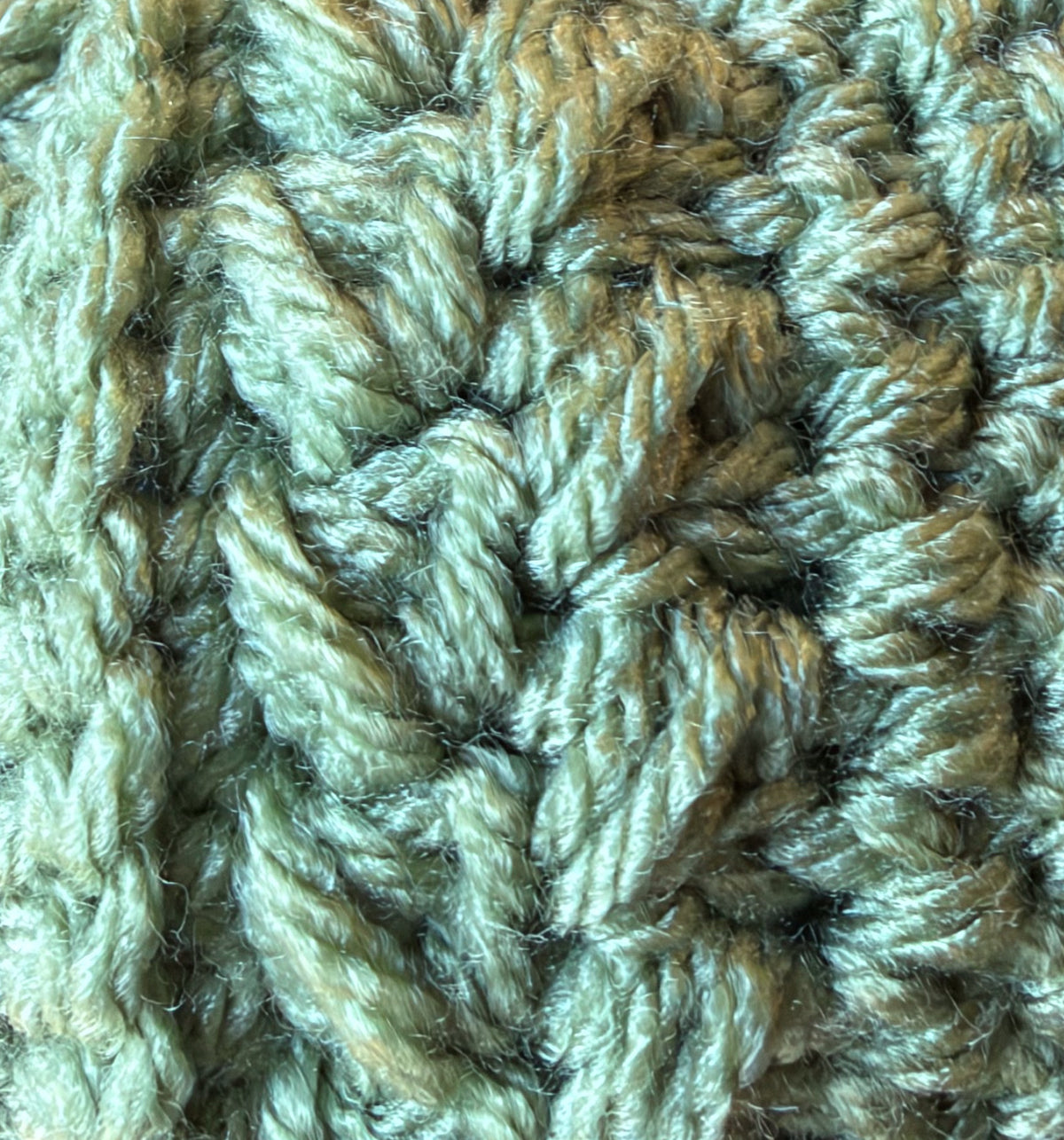 Close-up of crochet stitches in Light Sage, a soft green