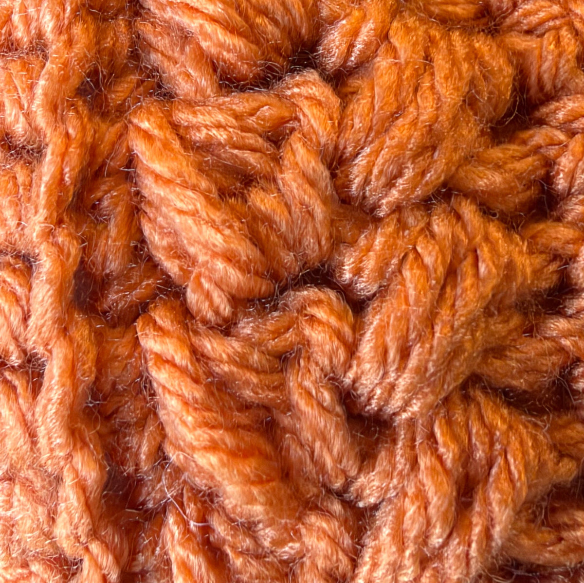 Close-up of crochet stitches in Desert Glaze, a soft light orange
