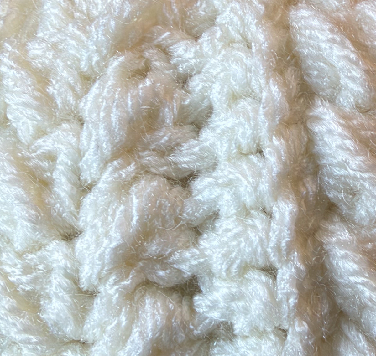 Close-up of crochet stitches in Ivory, a creamy white