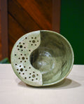 Hand-thrown ceramic berry bowl with a hand-punched drain panel, in soft sage Mosswood