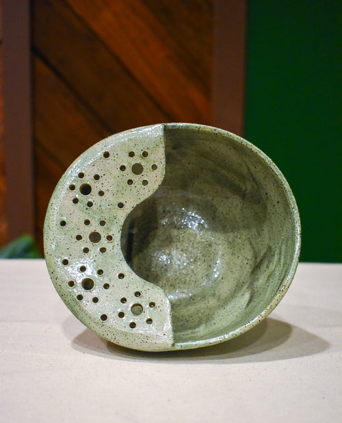 Hand-thrown ceramic berry bowl with a hand-punched drain panel, in soft sage Mosswood