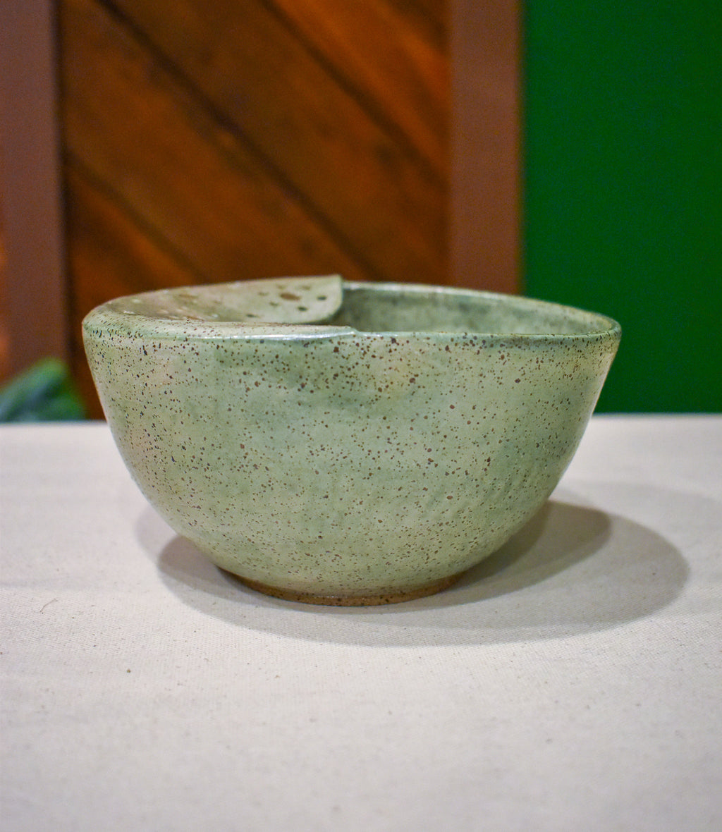 Hand-thrown ceramic berry bowl with a hand-punched drain panel, in soft sage Mosswood