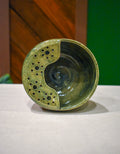 Hand-thrown ceramic berry bowl with a hand-punched drain panel, in moss-green Canopy