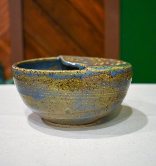 Hand-thrown ceramic berry bowl with a hand-punched drain panel, in periwinkle-blue Chicory