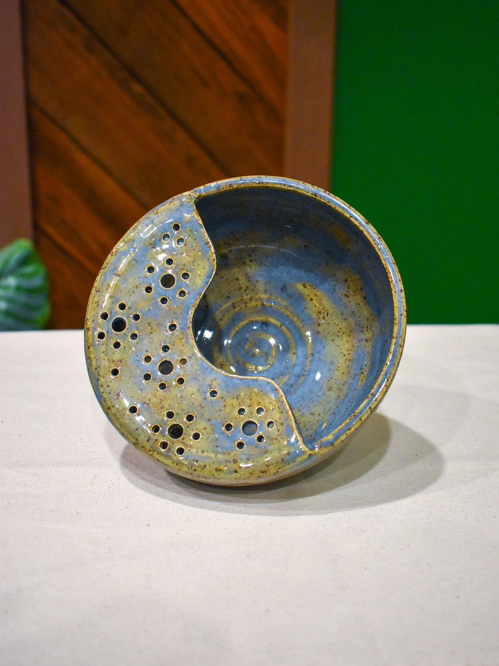 Hand-thrown ceramic berry bowl with a hand-punched drain panel, in periwinkle-blue Chicory
