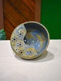 Hand-thrown ceramic berry bowl with a hand-punched drain panel, in periwinkle-blue Chicory