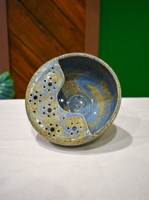 Hand-thrown ceramic berry bowl with a hand-punched drain panel, in periwinkle-blue Chicory
